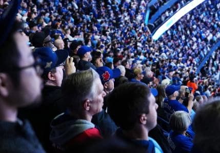 Fans watch the opening ceremonies before a game between the Athletics and the Toronto Blue Jays at Rogers Centre.