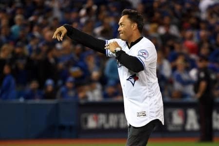 Toronto Blue Jays former player Roberto Alomar throws out the first pitch before the American League wild card playoff baseball game between the Toronto Blue Jays and the Baltimore Orioles at Rogers Centre.