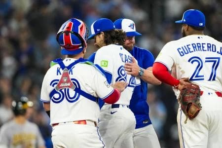 Toronto Blue Jays pitcher Dylan Cease (84) is relived by manager John Schneider (14) during the sixth inning at a MLB game against the Athletics at Rogers Centre.