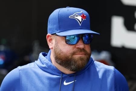 Toronto Blue Jays manager John Schneider looks on from the dugout before a baseball game against the Chicago White Sox at Rate Field.