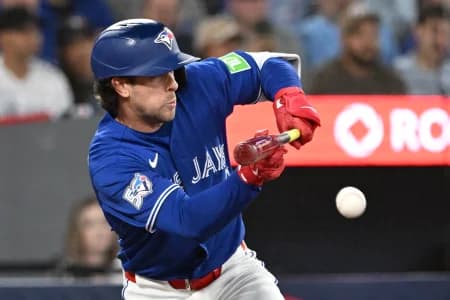 Toronto Blue Jays second baseman Ernie Clement (22) bunts to get on base against the Los Angeles Dodgers in the seventh inning at Rogers Centre.