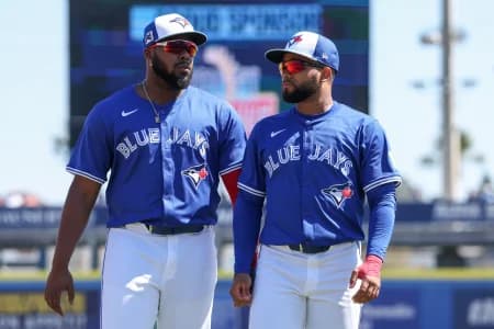 Toronto Blue Jays first baseman Vladimir Guerrero Jr. (27) and Toronto Blue Jays outfielder Steward Berroa (37) warm up before a game against the Philadelphia Phillie during spring training at TD Ballpark.