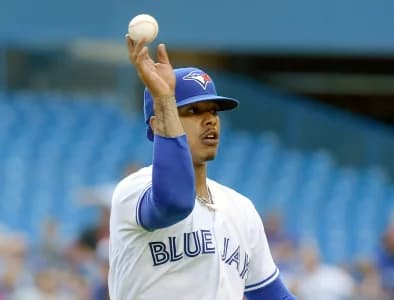 Toronto Blue Jays pitcher Marcus Stroman (6) flips the ball to first base after fielding a ball hit by Kansas City Royals shortstop Humberto Arteaga (not pictured) in the fourth inning at Rogers Centre.