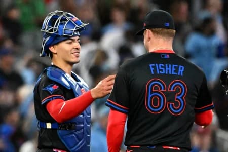 Toronto Blue Jays catcher Brandon Valenzuela (59) and relief pitcher Braydon Fisher (63) celebrate a win over the Minnesota Twins at Rogers Centre.