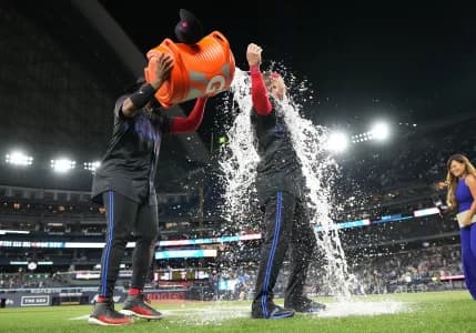 Toronto Blue Jays first basema Vladimir Guerrero Jr. (27) pours water on designated hitter Justin Turner (2) after a game against the Tampa Bay Rays at Rogers Centre.