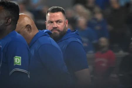 Toronto Blue Jays manager John Schneider (14) looks back towards the dugout as he lines up for the pre-game national anthems before playing the Los Angeles Dodgers at Rogers Centre.