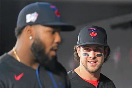 Toronto Blue Jays second baseman Ernie Clement (22, right) speaks with first baseman Vladimir Guerrero Jr. (27) before taking the field against the Minnesota Twins at Rogers Centre.