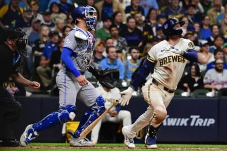 Milwaukee Brewers second baseman Brice Turang (2) drives in the go-ahead run with a groundout in the eighth inning as Toronto Blue Jays catcher Brandon Valenzuela (59) looks on at American Family Field.