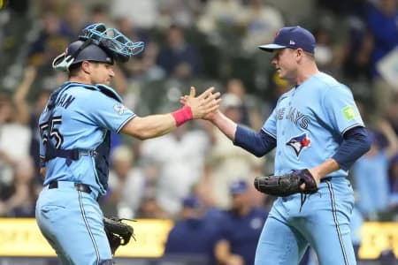 Toronto Blue Jays catcher Tyler Heineman (55) greets pitcher Louis Varland (77) following the game against the Milwaukee Brewers at American Family Field.