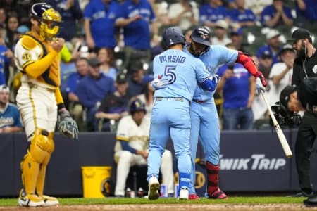 Toronto Blue Jays center fielder Daulton Varsho (5) celebrates with first baseman Vladimir Guerrero Jr. (27) after hitting a home run during the sixth inning against the Milwaukee Brewers at American Family Field.