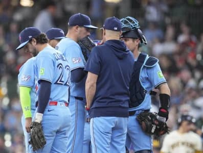 /41/ talks with Toronto Blue Jays pitcher Patrick Corbin (46) and Toronto Blue Jays catcher Tyler Heineman (55) in the fourth inning against there Milwaukee Brewers at American Family Field.