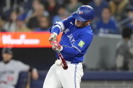 Toronto Blue Jays center fielder Daulton Varsho (5) hits a one run single against the Minnesota Twins during the first inning at Rogers Centre.
