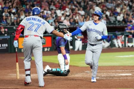 Toronto Blue Jays center fielder Myles Straw (3) slaps hands with Toronto Blue Jays first baseman Vladimir Guerrero Jr. (27) after hitting a solo home run against the Arizona Diamondbacks during the sixth inning at Chase Field