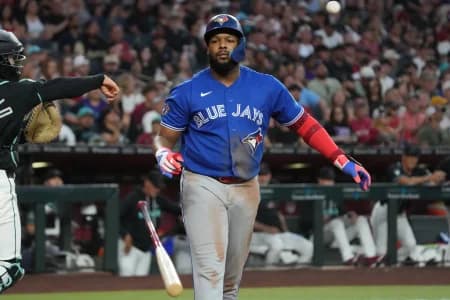 Toronto Blue Jays first baseman Vladimir Guerrero Jr. (27) throws his bat after striking gout against the Arizona Diamondbacks in the seventh inning at Chase Field.