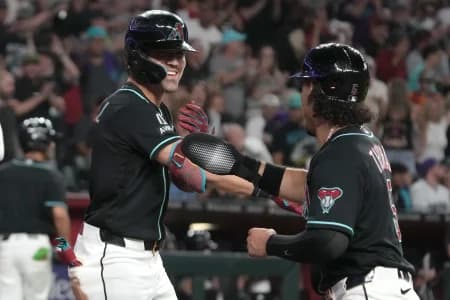 Arizona Diamondbacks right fielder Corbin Carroll (7) celebrates with center fielder Alek Thomas (5) after hitting a grand slam against the Toronto Blue Jays in the eighth inning at Chase Field.