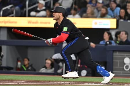 Toronto Blue Jays center fielder Daulton Varsho (5) hits a double against the Minnesota Twins in the first inning at Rogers Centre.
