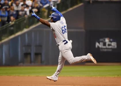 Los Angeles Dodgers outfielder Yasiel Puig (66) celebrates after hitting a three-run home run against the Milwaukee Brewers in the sixth inning in game seven of the 2018 NLCS playoff baseball series at Miller Park.