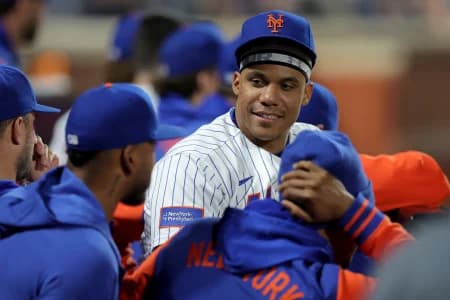 New York Mets designated hitter Juan Soto (22) talks to teammates in the dugout during the ninth inning against the Minnesota Twins at Citi Field.