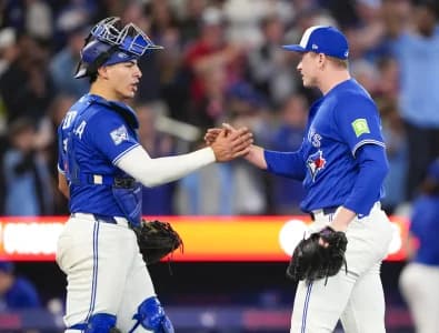 Toronto Blue Jays pitcher Louis Varland (77) and catcher Brandon Valenzuela (59) celebrate after defeating the Cleveland Guardians at Rogers Centre.