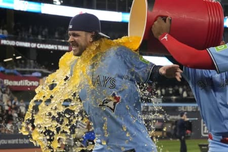 Toronto Blue Jays second baseman Ernie Clement (22) gets soaked with gatorade by first baseman Vladimir Guerrero Jr. (not pictured) after a win over the Boston Red Sox at Rogers Centre.