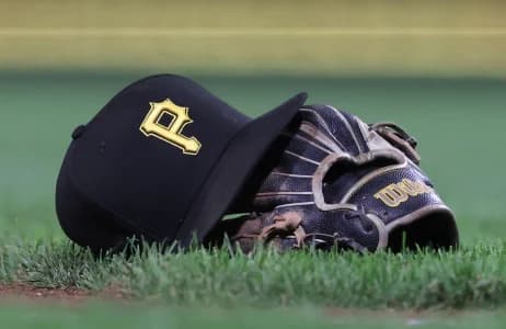 A hat and glove belonging to Pittsburgh Pirates third baseman Jared Triolo (not pictured) on the field against the Chicago Cubs during the sixth inning at PNC Park.