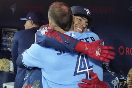 Toronto Blue Jays designated hitter George Springer (4) congratulates catcher Brandon Valenzuela (59) on hitting a solo home run against the Boston Red Sox in the eighth inning at Rogers Centre.