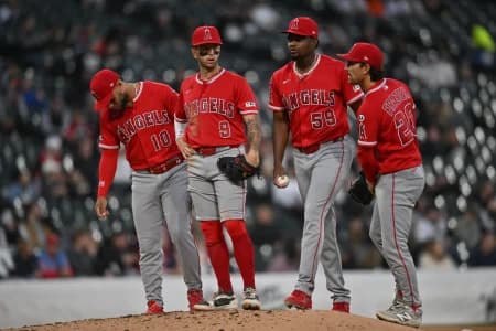 Los Angeles Angels pitcher Jose Soriano (59) meets with third baseman Yoan Moncada (10), shortstop Zach Neto (9) and baseman Adam Frazier (20) at the mound against the Chicago White Sox during the third inning at Rate Field.