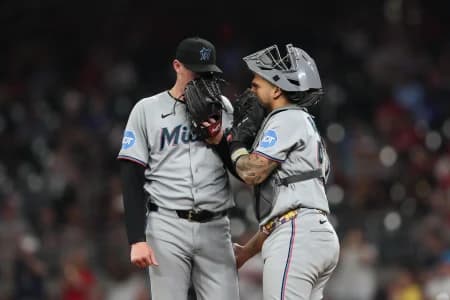 Miami Marlins pitcher Pete Fairbanks (29) and Miami Marlins catcher Agustin Ramirez (50) meet on the mound against the Atlanta Braves in the eight inning at Truist Park.