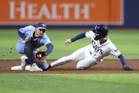 Tampa Bay Rays right fielder Jonny DeLuca (21) steals second base from Toronto Blue Jays shortstop Andres Gimenez (0) in the seventh inning at Tropicana Field.