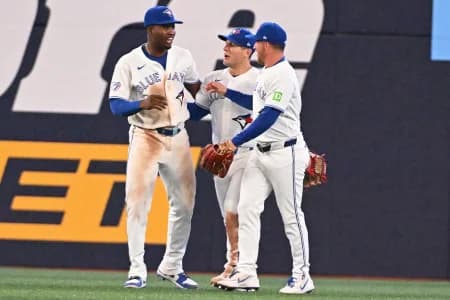 Toronto Blue Jays left field Jesus Sanchez (12) celebrates the victory over the Los Angeles Angels with center field Daulton Varsho (5) and right field Myles Straw (3) at Rogers Centre.