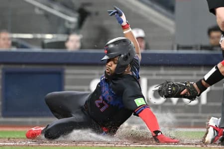 Toronto Blue Jays first baseman Vladimir Guerrero Jr. (27) scores against Los Angeles Angels catcher Sebastian Rivero (38) in the third inning at Rogers Centre.