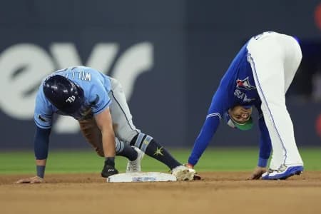 Toronto Blue Jays shortstop Andres Gimenez (0) catches Tampa Bay Rays pinch runner Ben Williamson (15) trying to steal second base during the ninth inning at Rogers Centre.