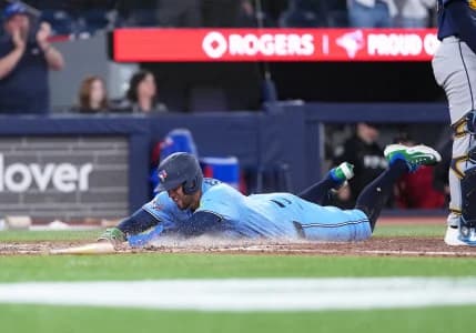 Toronto Blue Jays designated hitter George Springer (4) slides into home plate scoring a run against the Tampa Bay Rays during the seventh inning at Rogers Centre.