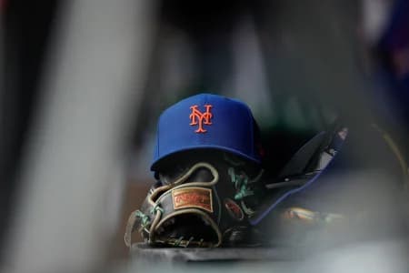 A New York Mets hat and glove in the dugout in the second inning against the Colorado Rockies at Coors Field.