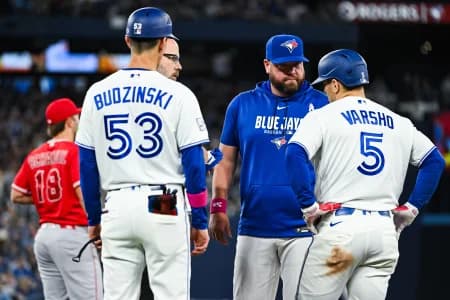 Toronto Blue Jays manager John Schneider checks in with center fielder Daulton Varsho (5) after a potential injury against the Los Angeles Angels in the eigth inning at Rogers Centre.