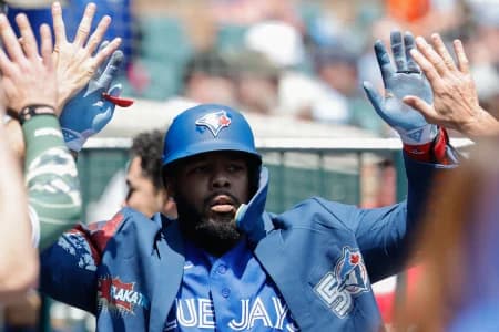 Toronto Blue Jays first baseman Vladimir Guerrero Jr. (27) receives congratulations from teammates after he hits a home run in the first inning against the Detroit Tigers at Comerica Park.