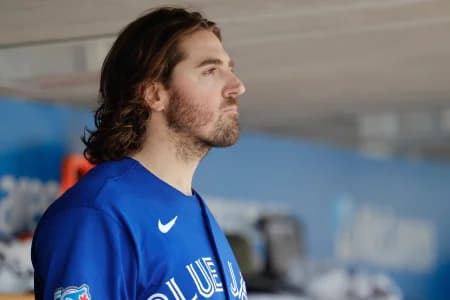 Toronto Blue Jays pitcher Kevin Gausman (34) watches from the dugout in the sixth inning against the Detroit Tigers at Comerica Park.