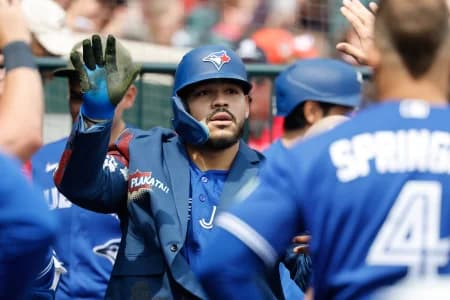 Toronto Blue Jays left fielder Yohendrick Pinango (24) receives congratulations from teammates after he hits a home run in the seventh inning against the Detroit Tigers at Comerica Park.
