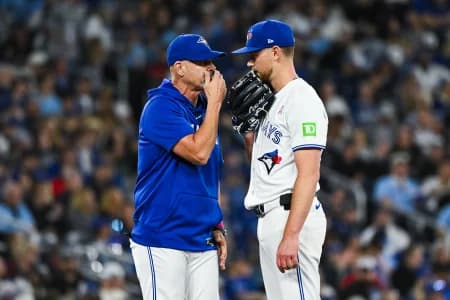 Toronto Blue Jays starting pitcher Eric Lauer (56) has a discussion with pitching coach Pete Walker (40) against the Los Angeles Angels in the fifth inning at Rogers Centre.