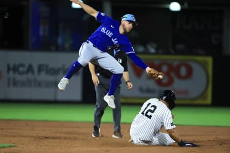Toronto Blue Jays infielder Rafael Lantigua (72) attempted to tag out New York Yankees center fielder Trent Grisham (12) as he stole second base during the fifth inning at George M. Steinbrenner Field.