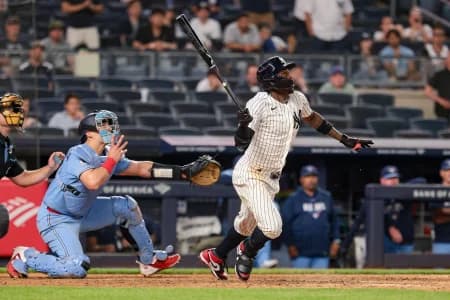 New York Yankees second baseman Jazz Chisholm Jr. (13) hits an infield single during the ninth inning against the Toronto Blue Jays at Yankee Stadium.