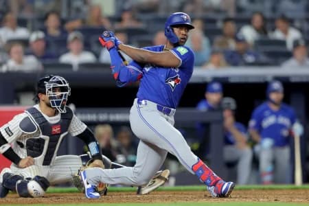 Toronto Blue Jays right fielder Jesus Sanchez (12) follows through on an RBI double against the New York Yankees during the ninth inning at Yankee Stadium.