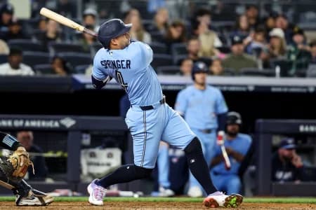 Toronto Blue Jays designated hitter George Springer (4) hits a solo home run in the seventh inning against the New York Yankees at Yankee Stadium.