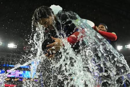 Toronto Blue Jays left fielder Yohendrick Pinango (24) gets doused with ice water by Toronto Blue Jays first baseman Vladimir Guerrero Jr. (27) after a win against the Pittsburgh Pirates at Rogers Centre.