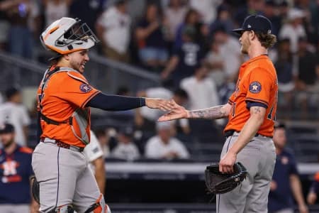 Houston Astros relief pitcher Josh Hader (71) celebrates with catcher Yainer Diaz (21) after defeating the New York Yankees at Yankee Stadium.
