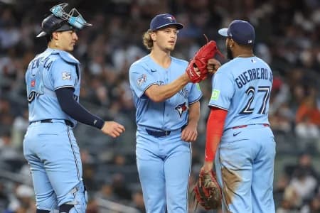 Toronto Blue Jays relief pitcher Adam MacKo (64) is greeted by catcher Brandon Valenzuela (59) and first baseman Vladimir Guerrero Jr. (27) after getting taken out of the game in the third inning against the New York Yankees at Yankee Stadium.