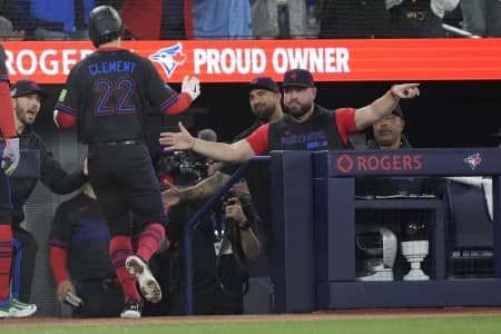 Toronto Blue Jays manager John Schneider congratulates second baseman Ernie Clement (22) after he scores against the Pittsburgh Pirates during the eighth inning at Rogers Centre