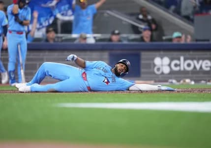Toronto Blue Jays first baseman Vladimir Guerrero Jr. (27) gets hit with a pitch against the Pittsburgh Pirates during the fifth inning at Rogers Centre.