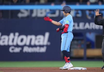 Toronto Blue Jays third baseman Kazuma Okamoto (7) celebrates hitting a double against the Pittsburgh Pirates during the second inning at Rogers Centre.