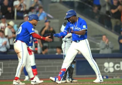 Toronto Blue Jays right fielder Jesus Sanchez (12) hits a grand slam home run and celebrates with first baseman Lenyn Sosa (50) gainst the Miami Marlins during the sixth inning at the Rogers Centre.